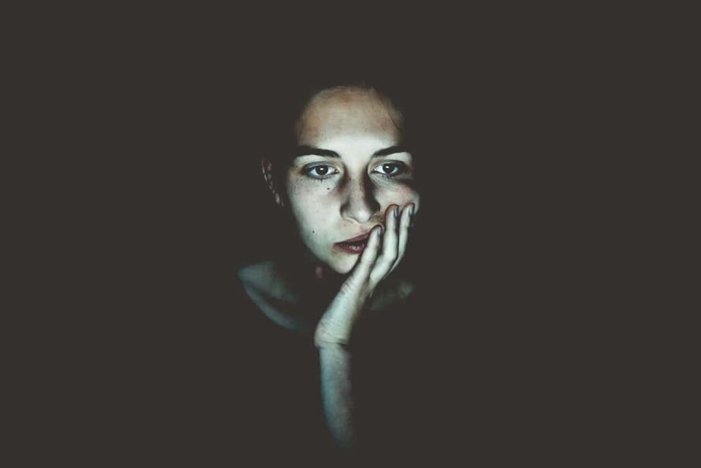 Woman's face illuminated by screen