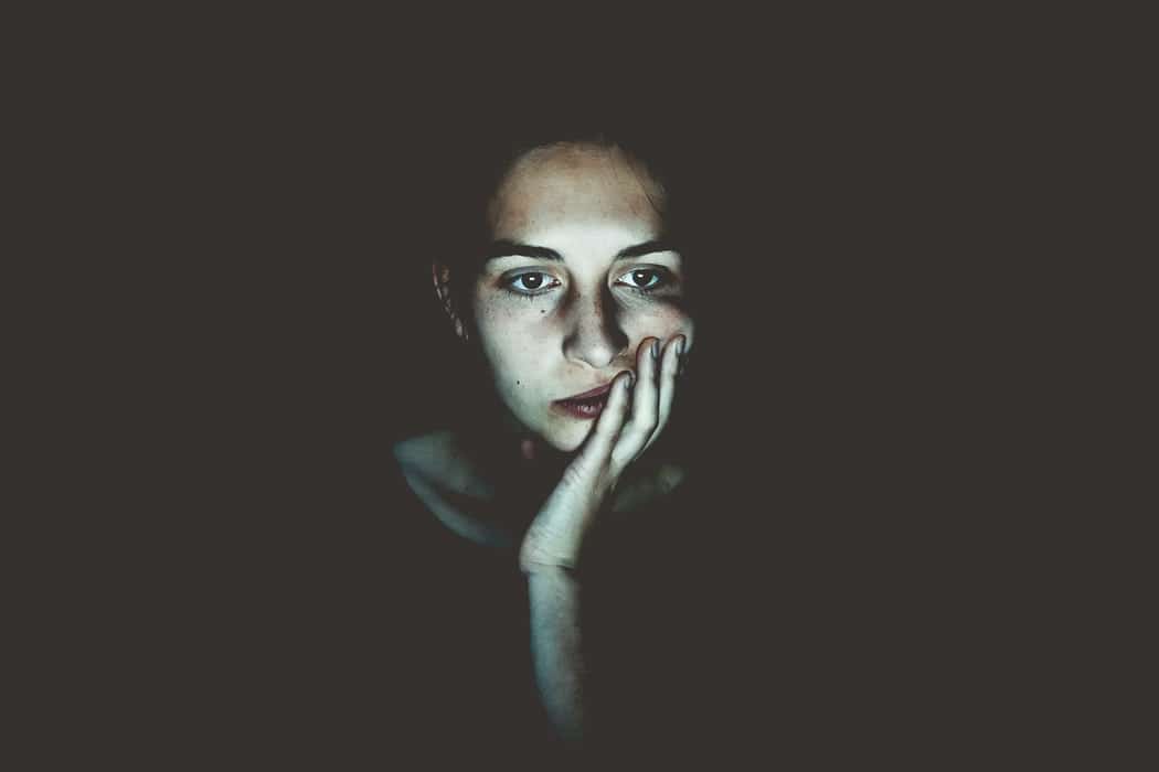 Woman's face illuminated by screen