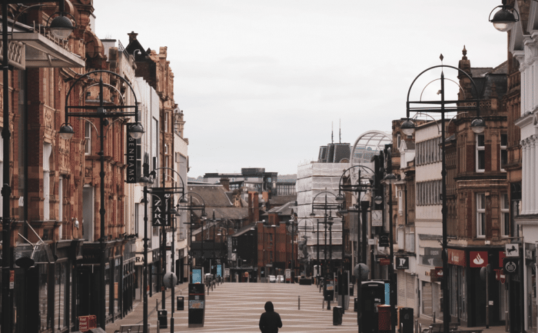 View of Briggate, Leeds with a lone, hooded figure walking away